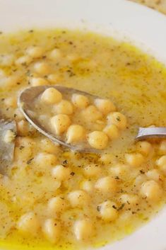 a white bowl filled with soup and a spoon