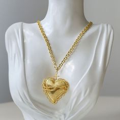 Featuring a sleek and simple design concept, this necklace features a striking oversized heart-shaped pendant in a shiny gold finish, exuding timeless elegance and modern appeal. The layered design adds depth and dimension, creating a chic sophistication. Metal: 18K Recycled Gold Plated On Brass Necklace Diameter: 39-44cm (pendant length 55mm) Weight: 32.5g Valentine's Day Gold Necklace With Intricate Design, Gold Necklace With Large Heart Pendant, Gold Bohemian Necklace For Valentine's Day, Handmade Gold Heart Pendant Necklace, Gold Heart Filigree Necklace, Gold Filigree Heart Necklace, Vintage Gold Necklace With Heart Beads, Insta Baddie, Edison Pearls