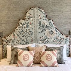 an ornate headboard with pillows on top of it