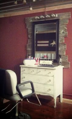 a white dresser sitting in front of a mirror