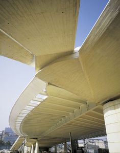 the underside of a large building that is very tall and has many curved sections on it