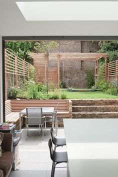 an open living room and dining area with sliding glass doors that lead to a garden