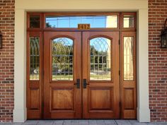 the front door to a home with two sidelights and glass panels on either side