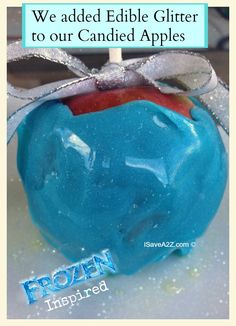 a blue apple with a ribbon tied around it and the words, we added edible glitter to our candied apples