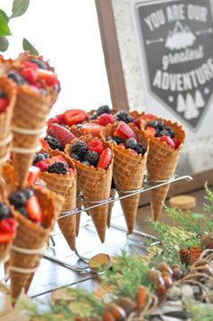 several cones filled with fruit on top of a table