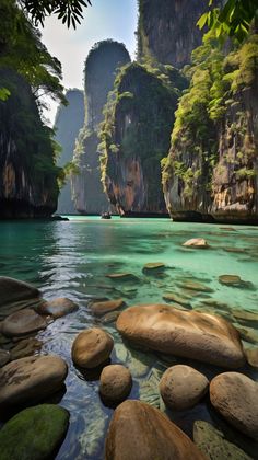 the water is crystal blue and green with rocks in it, as well as mountains