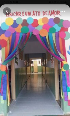 an entrance to a school decorated with colorful streamers and paper decorations on the door