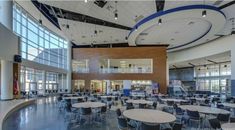 an empty cafeteria with tables and chairs in it