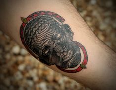 a close up of a person's arm with a tattoo on it and a gorilla head