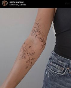 a woman with a flower tattoo on her arm