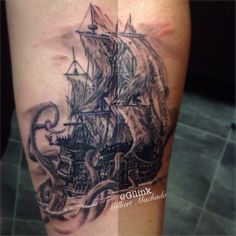 a black and white photo of an octopus attacking a pirate ship tattoo on the leg