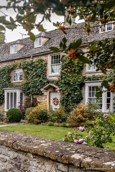 an old stone house with ivy growing on it