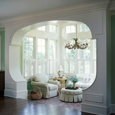 a living room filled with furniture and windows