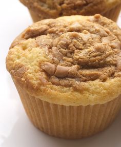 two muffins sitting next to each other on a white surface