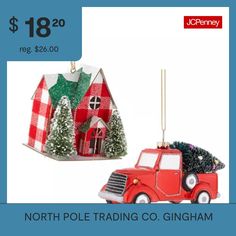 a christmas ornament with a red truck carrying a tree and a house on it