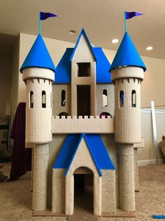 a castle made out of cardboard with blue turrets