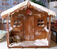 a doll house made out of wood and snow