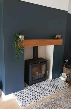 a living room with blue walls and a wood burning stove