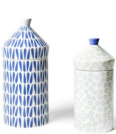 two blue and white vases sitting next to each other