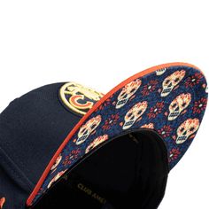 FI Collection Club America Day of the Dead Snapback Hat - Navy-OrangeCommunity spirit and collective joy shine bright as color and tradition collide in this commemorative Fan Ink Club America Day of the Dead Snapback Hat. The classic 6-panel high crown silhouette is made up in a celebratory navy and orange palette with embroidered details including a front Club América crest, back Día de Muertos inscription, and a side Sugar Skull graphic. A contrast peak and top button add a pop of color, while Crown Silhouette, Orange Palette, Navy And Orange, Club America, Día De Muertos, Skull Graphic, Embroidered Details, Skull Print, Day Of The Dead