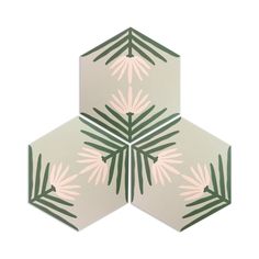 three hexagonal tiles with pink and green leaves on them, all arranged in the same pattern