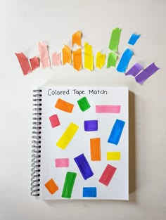 colored tape match on top of a notebook with crayons scattered around it and the words colored tape match written in black