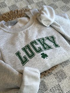 Celebrate St. Patty's Day with this Lucky Embroidered Sweatshirt! Perfect addition to your comfy outfit! *This sweatshirt is only offered in the color "ash" ~The Crewneck~ * Comfy Gildan 18000 sweatshirt * Fits true to size - see size guide chart in photos * For an oversized fit order 2 sizes up! * Embroidered in the USA * Embroidery stabilizer will be cut to the shape of the design ~Care~ * Machine wash cold, inside out, and with like colors  * Be mindful of the other materials you wash this it Game Day Embroidered Crew Neck Top, St Patricks Day Outfits, Embroidery Stabilizer, Usa Embroidery, St Patrick's Day Outfit, Sweatshirt Fits, Saint Patties, Comfy Outfit, Embroidered Sweatshirt