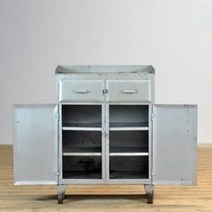 an old metal cabinet with two doors and drawers