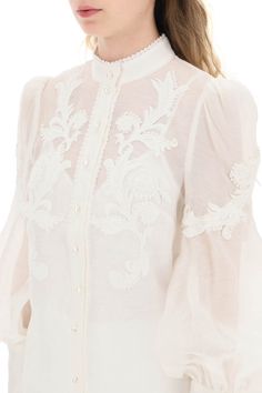 Zimmermann button-up blouse in linen silk organza, embellished with floral appliques and tonal beaded trimmings. Detailed with pearl-shaped buttons, it features a Mandarin collar, bouffant sleeves with long zip cuffs, and a removable jersey camisole with adjustable straps. The model is 177 cm tall and wears a size 1 Zimmermann. Size Info STANDARD Color Detail White Made In China Material 52%LI 48%SE Season One spring Season Two summer Product clothing Brand Zimmermann Size And Fit Elegant Tops With Embroidered Cuffs, Elegant Blouse With Embroidered Cuffs, Designer Floral Embroidered Tops For Formal Occasions, Elegant Fitted Tops With Embroidered Sleeves, Designer Formal Tops With Floral Embroidery, Elegant Fitted Tops With Embroidered Cuffs, Formal Long Sleeve Blouse With Embroidered Cuffs, Luxury Long Sleeve Tops For Wedding, Elegant Summer Blouse With Embroidered Cuffs