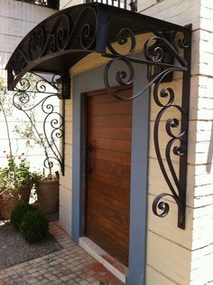 an iron and wood front door on a house