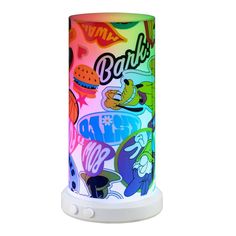 a colorful lamp that is on top of a white stand with an image of cartoon characters painted on it