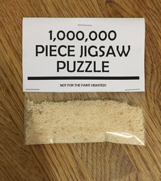 a piece of jigsaw puzzle on top of a wooden table next to a package