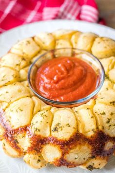 an appetizer on a plate with sauce in the middle and bread crusts around it