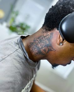 a man with a tattoo on his neck