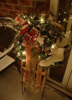 a sled with christmas decorations and lights on it in front of a door way