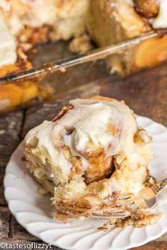 a piece of cinnamon roll on a plate with a fork