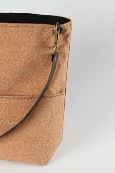 This vegan handbag is made from sustainably sourced cork, also known as vegan leather! The perfect vegan gift, our cork bags are beautiful, naturally waterproof, stylish and sustainable. Our casual, front pocket bucket bag in cork fabric is the perfect carryall for everyday use. The single strap makes it easy to swing over your shoulder; or add a longer, crossbody strap and easily transition to hands-free shopping, sightseeing and errands. Conveniently placed pockets, durable construction and a Eco-friendly Everyday Bags With Zipper Closure, Eco-friendly Bags With Zipper Closure, Cork Handbag, Cork Bag, Casual Tote Bag, Vegan Handbags, Vegan Leather Bag, Cork Fabric, Casual Tote