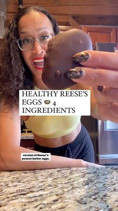 a woman holding up a chocolate doughnut in front of her face with the caption healthy reese's eggs 4 ingredients