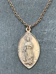 Saint Dymphna Necklace Solid bronze chain and medal Gold Oval Pendant Necklace In Copper, Gold Medallion Necklace In Copper, Bronze Medallion Necklace With Adjustable Chain, Gold Copper Oval Pendant Necklace, Symbolic Engraved Bronze Necklace, Gold Copper Medallion Necklace, Bronze Metal Medallion Necklace, Spiritual Bronze Necklace With Antique Finish, Bronze Spiritual Necklace With Antique Finish