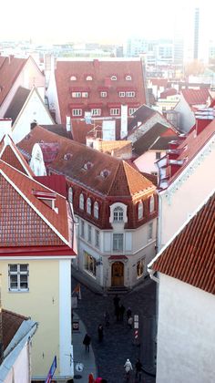 an aerial view of some buildings with red roofs