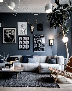 a living room filled with furniture and pictures on the wall