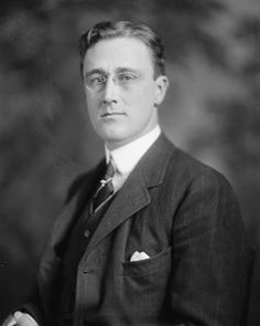 an old black and white photo of a man in a suit