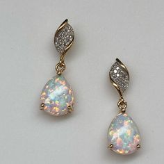 Set Securely At The Bottom Of The Earring Is A Pear Shape Created Opal. The Opal Has Beautiful Fire And Flash With Greens, Pinks, And Blues Throughout. They Measures 10 X 7mm Each And Are Securely Prong Set With 3 Prongs. They Sit In A Basket That Swing From A Small Ring Just Below A Wave Of Pave Set Diamonds At The Top. The Total Diamond Weight Is 0.10ct Twt. The Diamonds Are Set In White Rhodium Which Makes Them Look Much Larger! These Earrings Measure 3/4" From Top To Bottom. They Have Stud P Dangle Diamond Earrings, Pretty Earrings Dangle, White Opal Earrings, Fancy Jewelry Necklace, Small Ring, Ear Ring, Diamond Dangle Earrings, Opal Earrings Stud, Swarovski Crystal Earrings