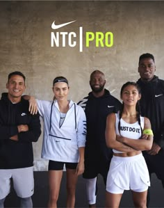 a group of people standing next to each other in front of a wall with the words ntc pro on it