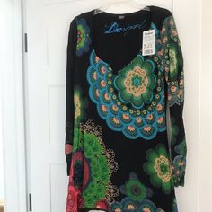 This New Desigual Dress/Tunic Is One That’s Hard For Me To Say Goodbye To. It Has Been In My Closet Way Too Long Without Even Getting The Tags Cut Off. I’ve Tried It On Several Times But Has Always Been Too Tight In The Shoulders For Me (I Just Bought The Wrong Size) But Was Hoping One Day It Would Fit Better. So Sad For Me But Might Be Your Lucky Day. Measurements Are In Pictures. Please Let Me Know If You Have Any Questions. From A Smoke Free Home. Offers Welcome Tags Need Removed! Black Printed Tunic Dress, Black Bohemian Tunic For Spring, Multicolor Fitted Long Sleeve Tunic, Fitted Multicolor Long Sleeve Tunic, Fitted Floral Print Tunic, Black Floral Print Tunic Dress, Green Floral Print V-neck Tunic, Black Tunic Dress With Floral Print, Black Long Sleeve Tunic For Vacation