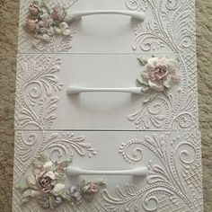 two white drawers with flowers on them