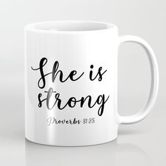 a white coffee mug with the words she is strong written in black ink on it