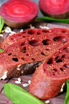 some food that is on top of a cutting board with green leaves and other foods