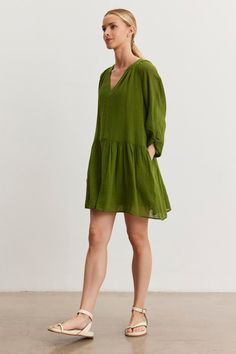 A woman in a green Sheer Sleeve Green Dress, Cotton Dress Green, Sheet Sleeve Dress, Gauze Clothing, Velvet Tees, Cami Shirt, Gauze Dress, Linen Shop, Sweater Sale