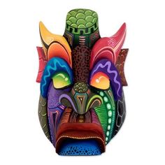 Marcos Rojas combines all of the colors of the Costa Rican jungle in this detailed mask. He carves it from balsa wood and combines rich hand-painted designs in contrasting colors throughout the piece. The mask comes with an agave fiber loop for easy installation and is signed by the artist as Arte indigena Boruca Costa Rica (Indigenous Boruca Art Costa Rica) in the back. Costa Rica's Boruca people have become famous for the whimsical masks that they create for their annual Dance of the Devils fe Tropical Wall Decor, Devil Mask, Wood Mask, The Devils, Mask Tattoo, Balsa Wood, White Mask, Painted Designs, Costa Rican